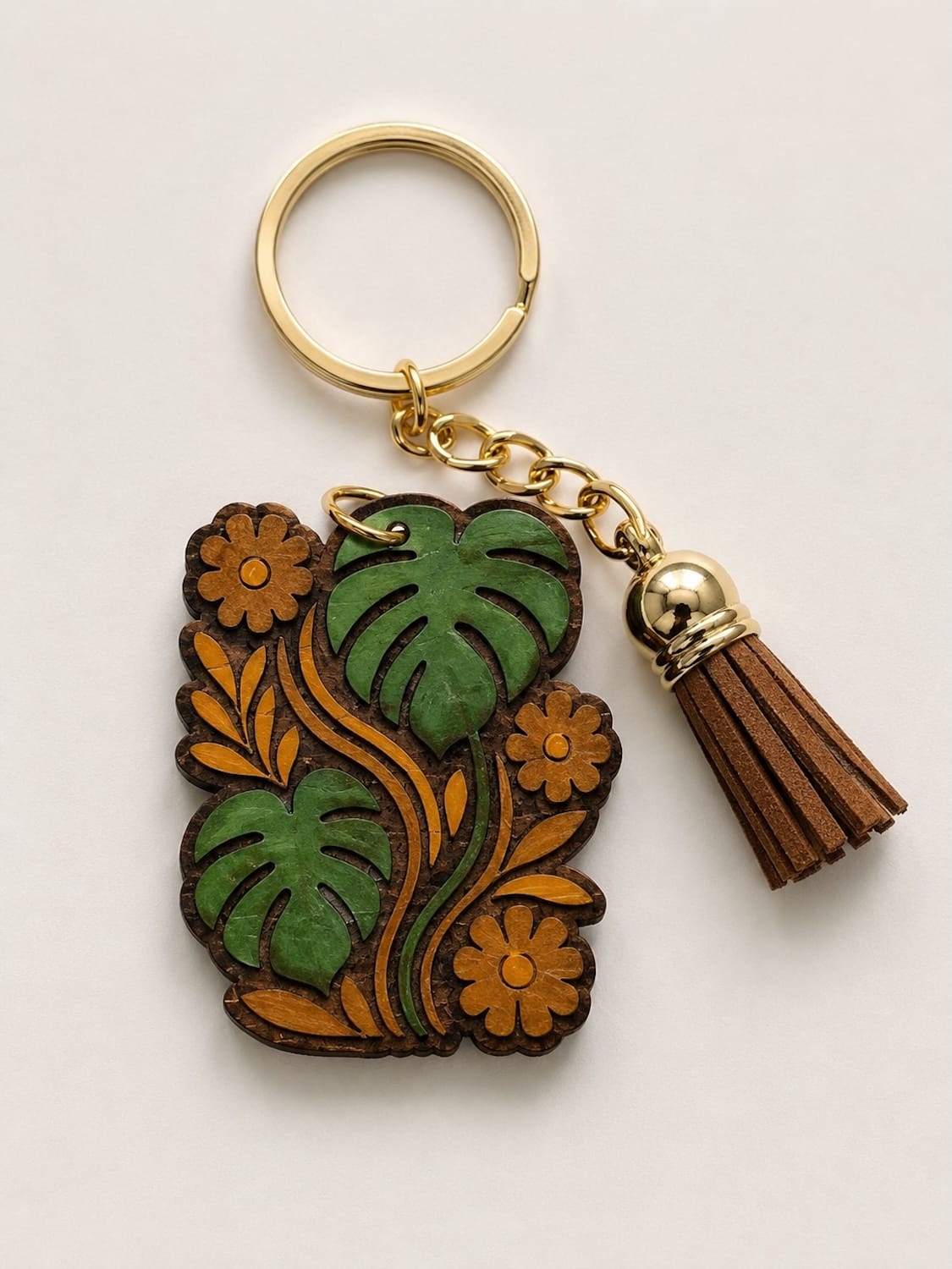 Keychain with floral design and tassel on a light background